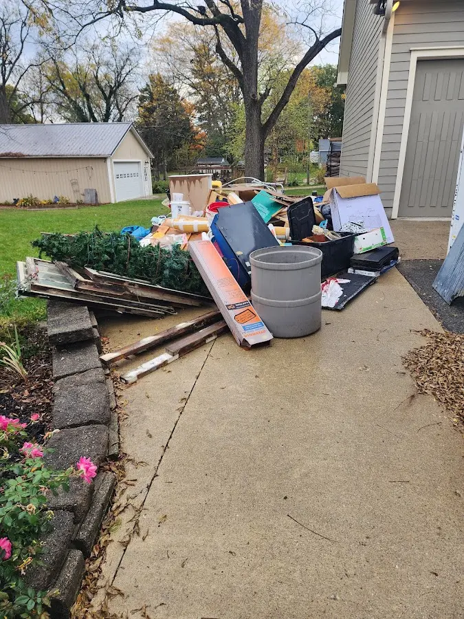 Dumpster being loaded with debris for Estate Cleanout Dumpster Rental in Appleton